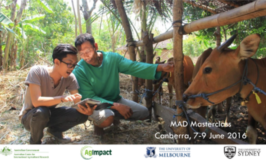 Front slide of quantity, quality and management presentation. Slide image of a field officer takes survey data on farmers cattle using a tablet as farmer looks on 