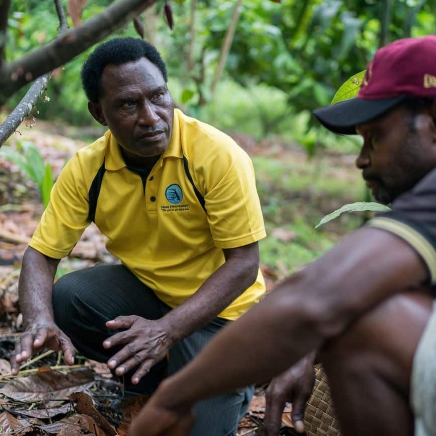 Kula Daslogo talks to a cocoa farmer outside Rabaul, East New Britain