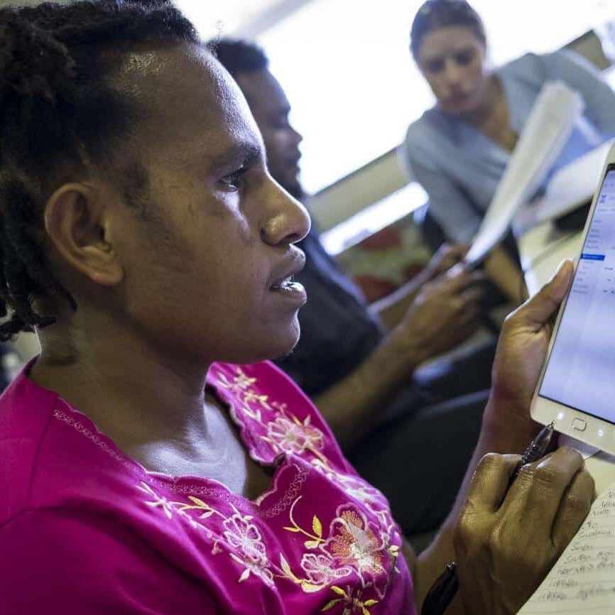 FPDA sweet potato project staff member Loncia Aris practices using a tablet